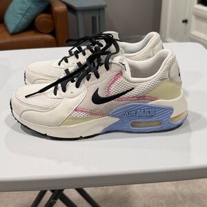 Nike Air Max women’s White Sneakers with Black, Pink and Blue Accents.